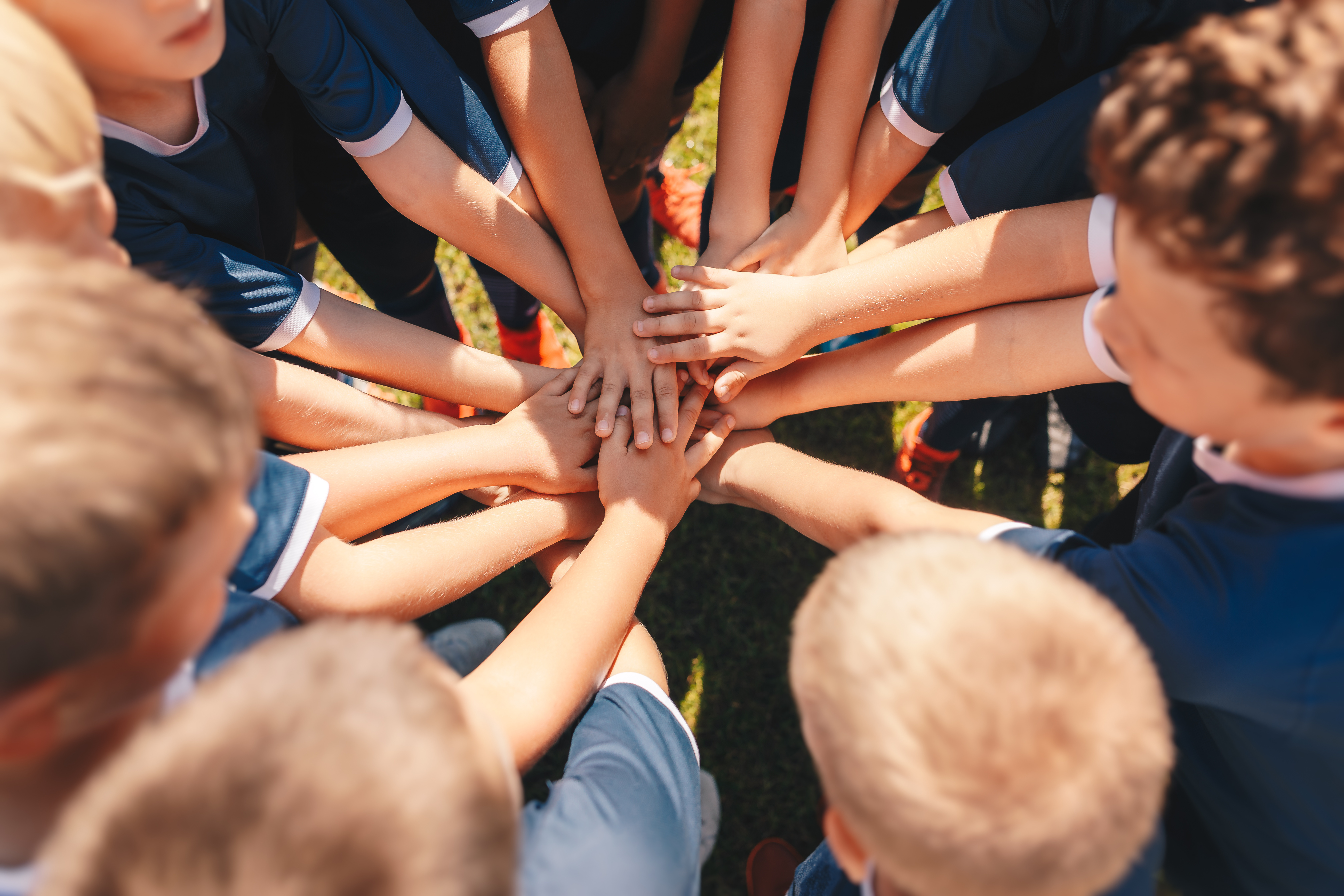 Football Team Stacking Their Hands  